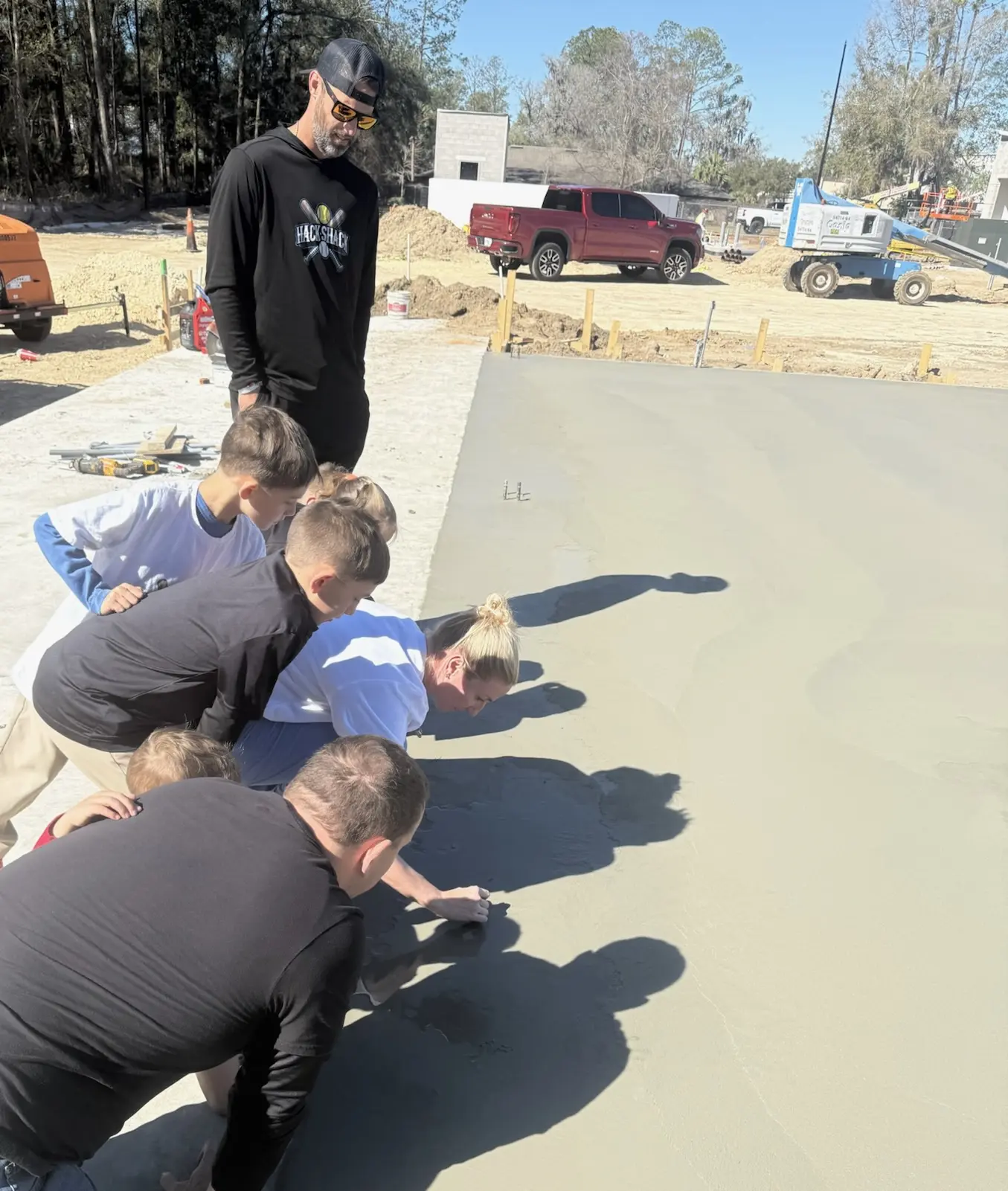 Kids touching wet concrete at construction site