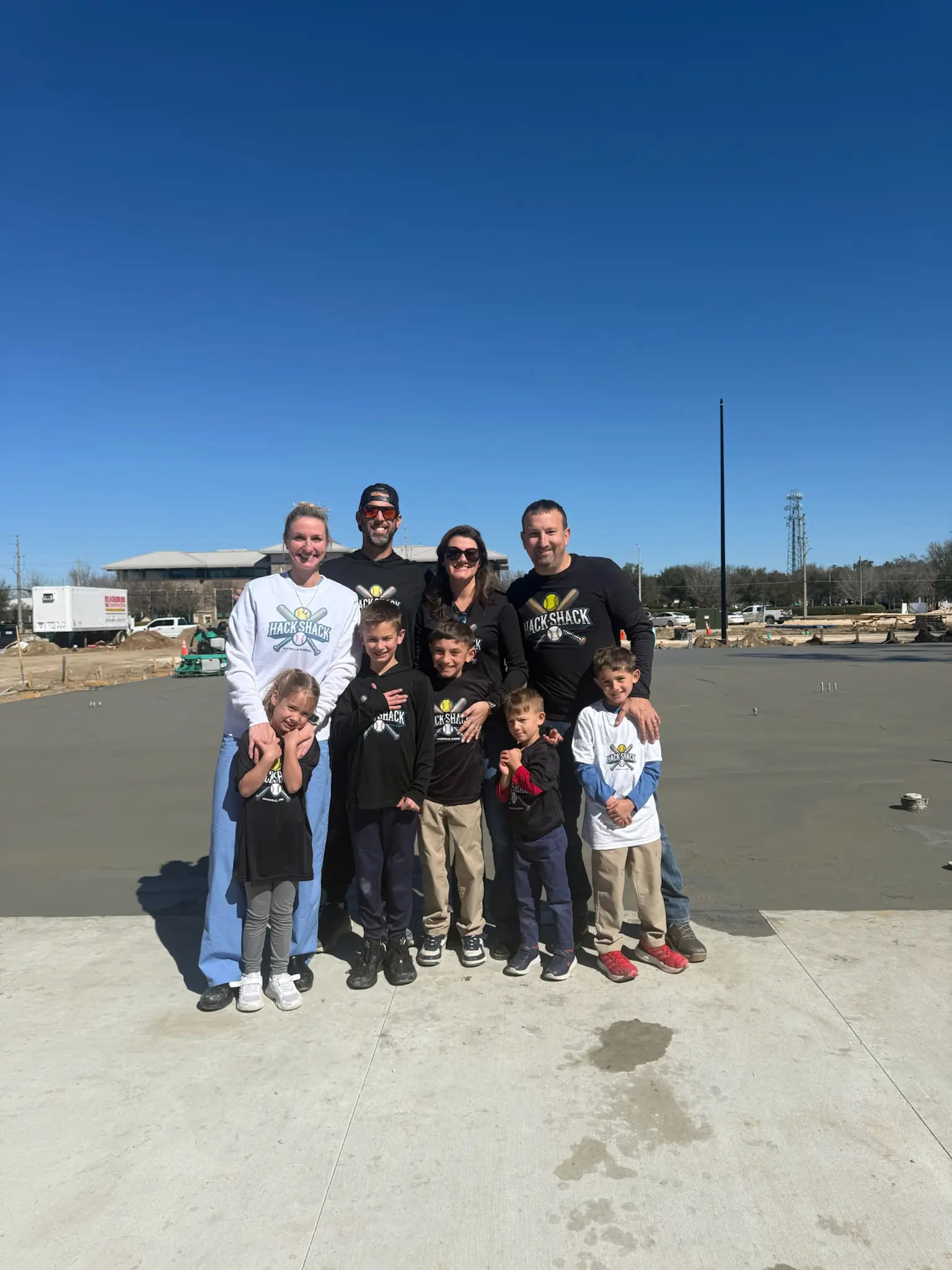 Group of adults and children at construction site