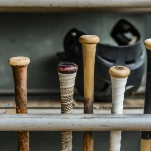 Row of baseball bat handles in a rack