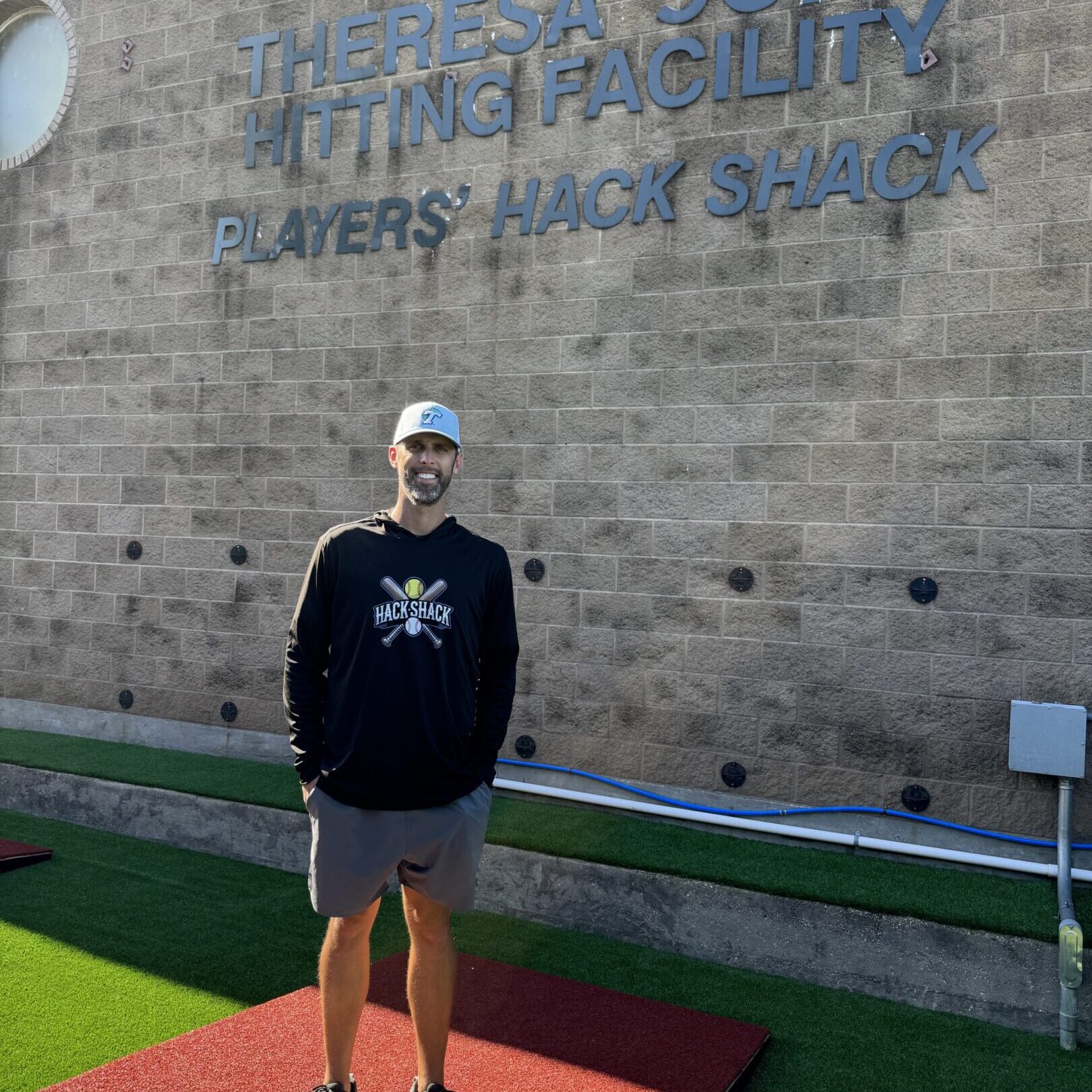 Man standing at hitting facility entrance